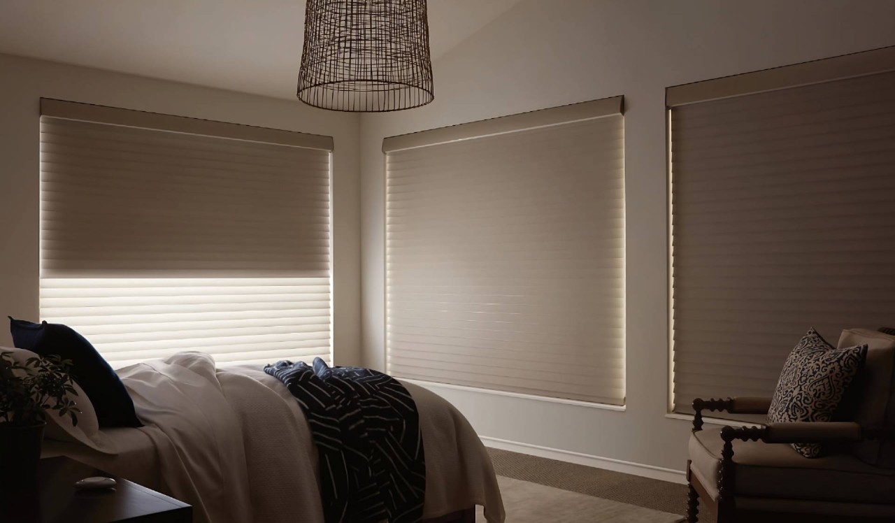 Hunter Douglas Silhouette® Sheer Shades as window shades on three windows in a neutral-themed bedroom at Geneva’s Interiors near Federal Way, (WA)