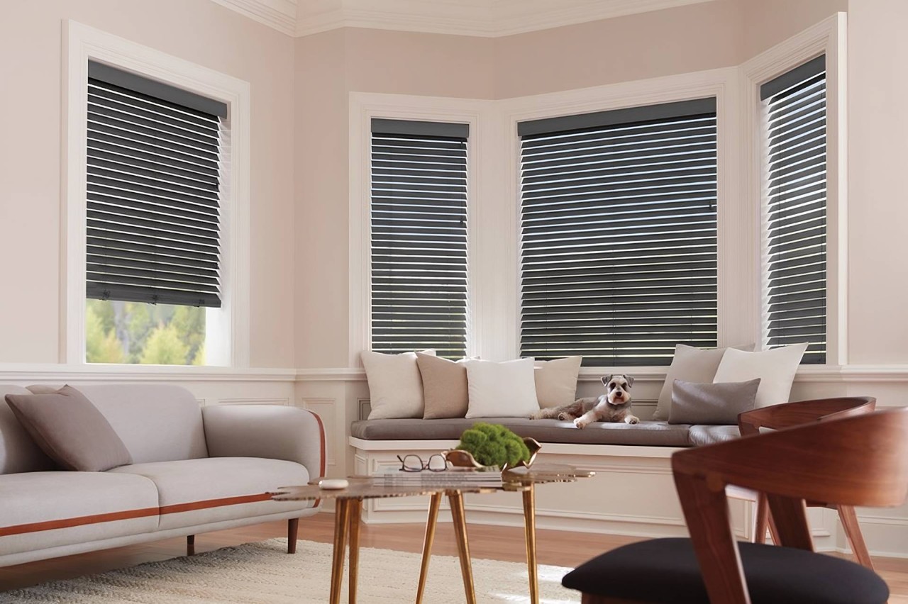 Hunter Douglas Parkland® Wood Blinds decorating Bay windows in a living room near Federal Way, WA